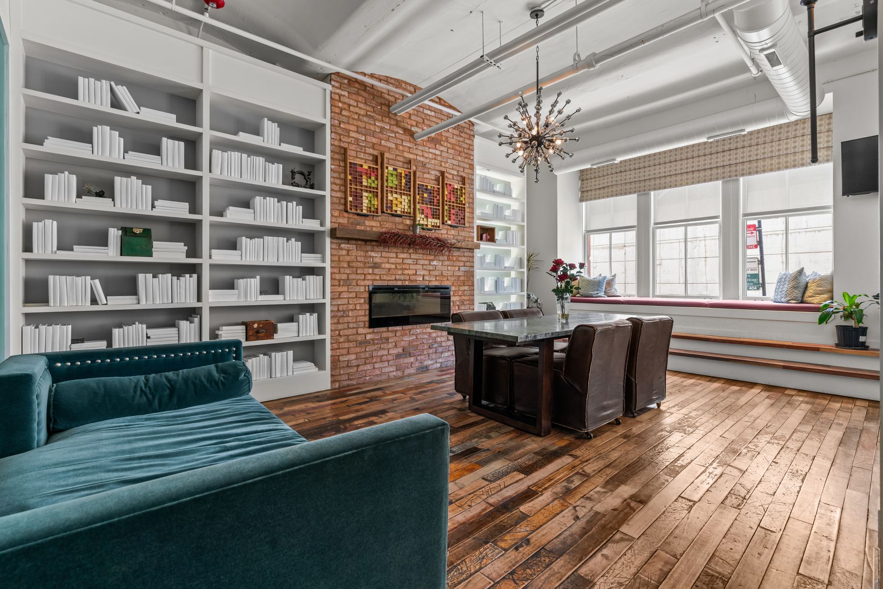 Library Lofts library lounge with brick fireplace